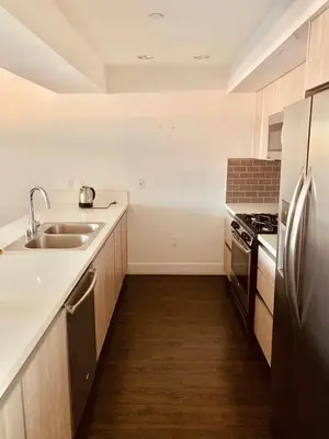 a kitchen with a sink and a refrigerator at Western Lemon Grove in Los Angeles