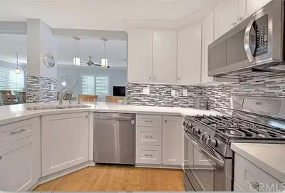 a kitchen with white cabinets and a stove top oven at Mountain View • Pool House in Chino Hills