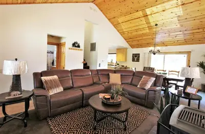 a living room with a brown leather couch and tables at Take a Break in Big Bear Lake