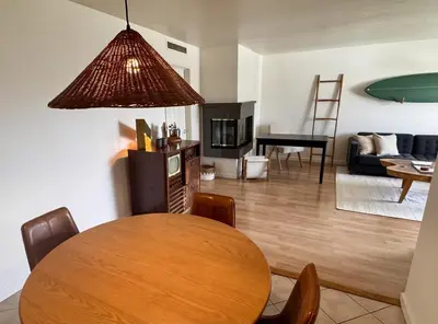 a living room with a wooden table and a dining room at Santa Monica 2BR Condo Views and Prime Location in Los Angeles
