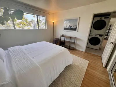 a bedroom with a large white bed and a window at Santa Monica 2BR Condo Views and Prime Location in Los Angeles