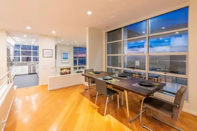 a dining room with a table and a large window at Stunning Panoramic Ocean Views Penthouse Hot Tub in Manhattan Beach