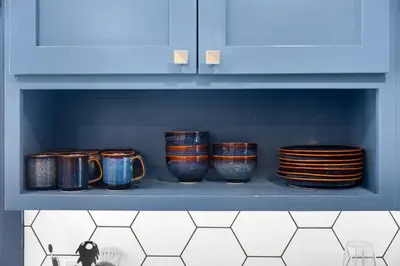 a shelf with several cups and plates on it at Charming 2BR in Heart of LA with Spacious Backyard in Los Angeles