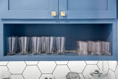a row of glasses on a shelf in a kitchen at Charming 2BR in Heart of LA with Spacious Backyard in Los Angeles