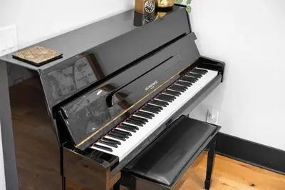 a black piano sitting on top of a table at Charming 2BR in Heart of LA with Spacious Backyard in Los Angeles