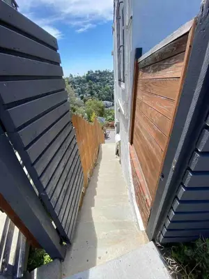 a walkway between two buildings with wooden gates at Private and Quiet Los Feliz Guest Suite with VIEWS in Los Angeles