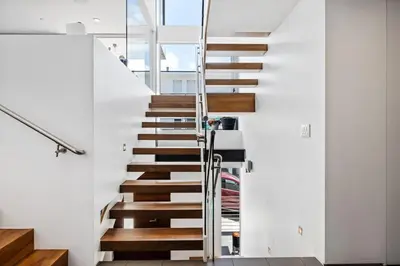 a staircase in a house with white walls at The Blue Wave - 3 blocks from Manhattan Beach Pier in Manhattan Beach