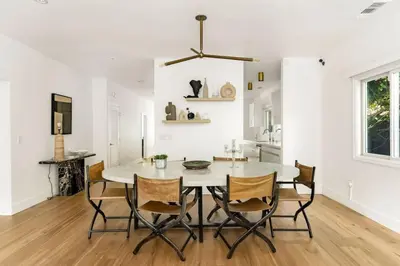 a kitchen and dining room with a table and chairs at Luxury Melrose District 3BR Retreat Pool Spa Gym in Los Angeles
