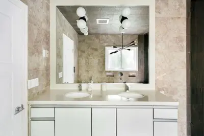 a bathroom with two sinks and a large mirror at Luxury Melrose District 3BR Retreat Pool Spa Gym in Los Angeles