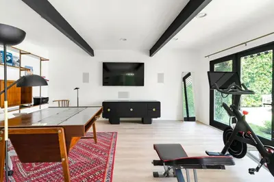 a living room with a ping pong table and a desk at Luxury Melrose District 3BR Retreat Pool Spa Gym in Los Angeles