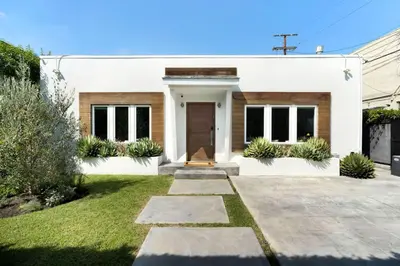 a white house with a cross in front of it at Luxury Melrose District 3BR Retreat Pool Spa Gym in Los Angeles