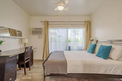 a bedroom with a bed and a desk and a window at Westwood UCLA 2BR, 1BA Cozy Condo w Amenities in Los Angeles
