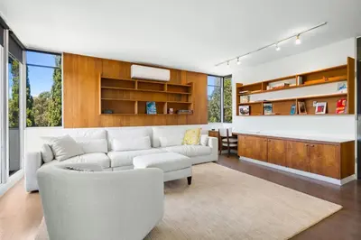 a living room with a white couch and a table at Hilltop Designer Midcentury Modern 4BR Pool HotTub in Los Angeles