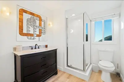 a bathroom with a toilet and a sink and a shower at Luxe Malibu Retreat - Ocean Views, Hot Tub and Gym in Malibu