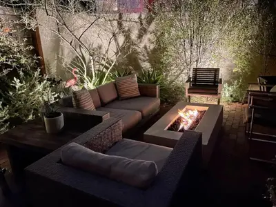 a patio with a couch and a fire pit at Chic Beach Bungalow 3 Blocks from the Sand in Manhattan Beach