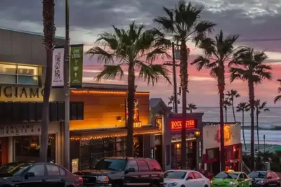 a city street with cars parked in front of buildings at Chic Beach Bungalow 3 Blocks from the Sand in Manhattan Beach