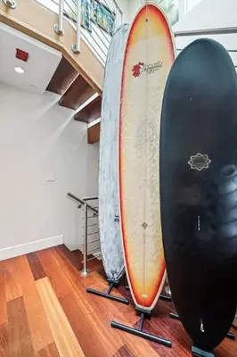 a couple of surfboards sitting next to a staircase at Lux by Manhattan Beach Pier and Panoramic Ocean View in Manhattan Beach
