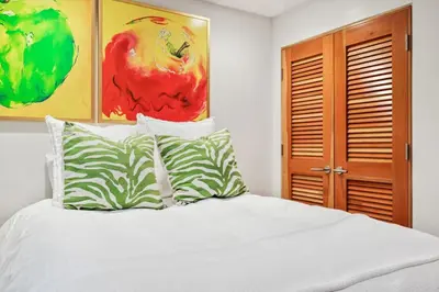 a white bed with two pillows on top of it at Lux by Manhattan Beach Pier and Panoramic Ocean View in Manhattan Beach