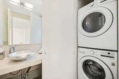 a bathroom with a washing machine and a sink at Private Designer Home in West Hollywood in Los Angeles