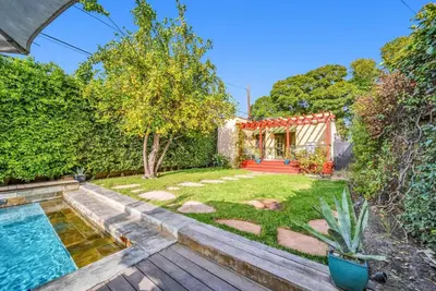 a garden with a swimming pool and a house at Atwater Oasis with Pool and HotTub very Walkable Area in Glendale