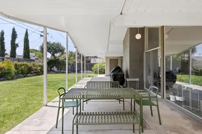 a patio with a table and chairs on a building at Eichler Mid-Century Perfect WFH, Relax and Entertain in Orange