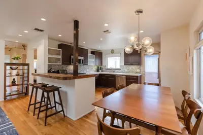 a kitchen and dining room with a table and chairs at Heart of Venice Designer Home Near Abbot Kinney in Los Angeles
