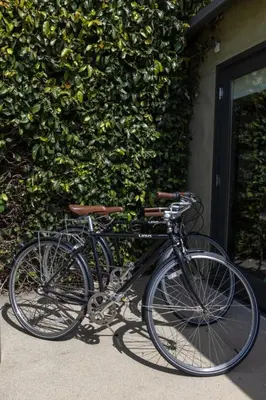 a black bike parked next to a building at Heart of Venice Designer Home Near Abbot Kinney in Los Angeles