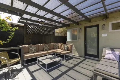 a pergola on a patio with a couch and a table at Heart of Venice Designer Home Near Abbot Kinney in Los Angeles