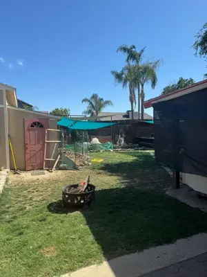 a backyard with a fire pit in the grass at Master bedroom in Bakersfield