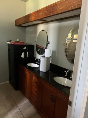a bathroom with two sinks and a mirror at Master bedroom in Bakersfield