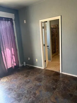 an empty room with a door and a mirror at Master bedroom in Bakersfield