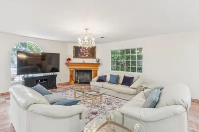 a living room with two white couches and a fireplace at Russell House Near Hollywood & Griffith Park home in Los Angeles