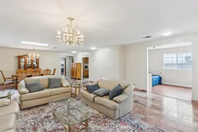 a living room with two couches and a chandelier at Russell House Near Hollywood & Griffith Park home in Los Angeles