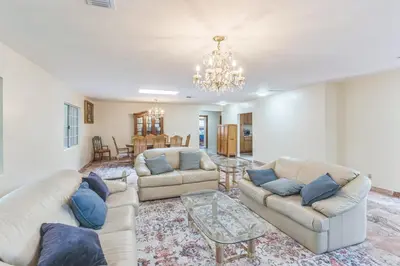 a living room with two couches and a chandelier at Russell House Near Hollywood & Griffith Park home in Los Angeles