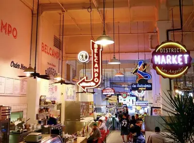 a store with many signs and people in it at DTLA 2BR Loft with Hot Tub & Rooftop Pool! in Los Angeles