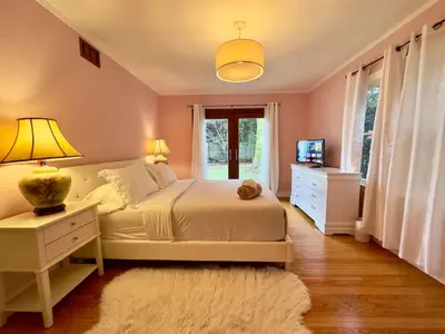 a bedroom with a white bed and a window at Tranquil Comfortable 2BR Home Mid Wilshire in Los Angeles