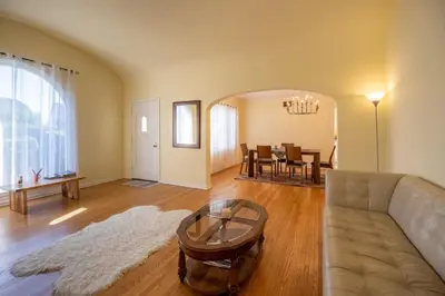 a living room with a couch and a table at Tranquil Comfortable 2BR Home Mid Wilshire in Los Angeles