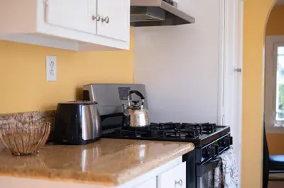 a kitchen counter with a stove top oven at Tranquil Comfortable 2BR Home Mid Wilshire in Los Angeles