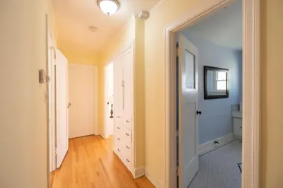 a hallway with a door open to a bathroom at Tranquil Comfortable 2BR Home Mid Wilshire in Los Angeles