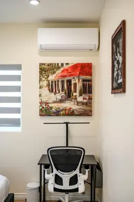 a room with a chair and a painting on the wall at Modern Getaway Near Pasadena & DTLA in Rosemead