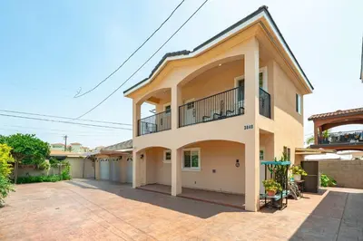 a house with a balcony on the side of it at Modern Getaway Near Pasadena & DTLA in Rosemead