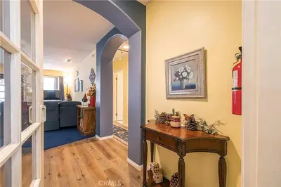 a hallway with a table and a living room at The Quiz Cottage Games & BBQ Outdoor Area! in Big Bear Lake