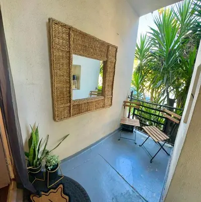 a mirror on a wall with two chairs and a balcony at Cozy home in Franklin Village, Central location! in Los Angeles
