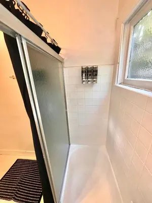 a shower with a glass door in a bathroom at Cozy home in Franklin Village, Central location! in Los Angeles