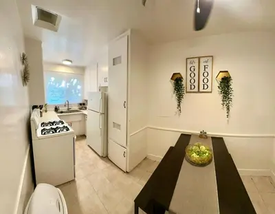 a kitchen with a table and a kitchen with a stove at Cozy home in Franklin Village, Central location! in Los Angeles