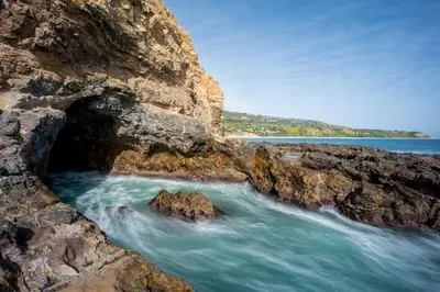 a cave in the rocks on a beach at LA Coastal Oasis in Rancho Palos Verdes