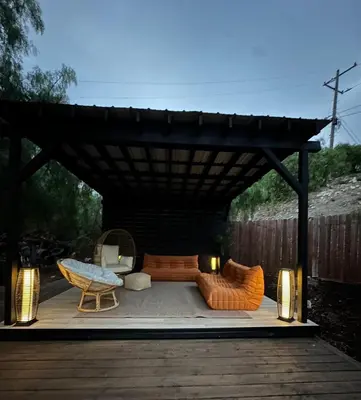 a pergola with two couches and chairs under it at LA Coastal Oasis in Rancho Palos Verdes