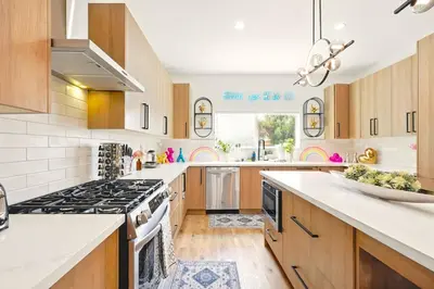 a kitchen with wooden cabinets and a stove top oven at G- Luxe NoHo Family Home near Universal 15m and Hollywood 10m in Hewitt
