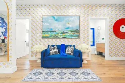 a living room with a blue couch and a painting at G- Luxe NoHo Family Home near Universal 15m and Hollywood 10m in Hewitt