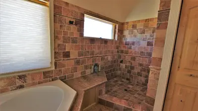 a bathroom with a tub and a window at Lakeside Oasis in Big Bear Lake